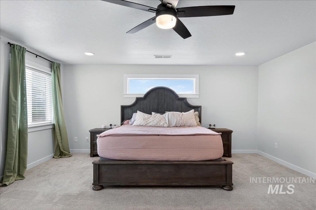 1993 North Perth Court Middleton, ID 83644 - Photo 22 of 45 Bedroom with a ceiling fan, light colored carpet, multiple windows, recessed lighting, and a textured ceiling