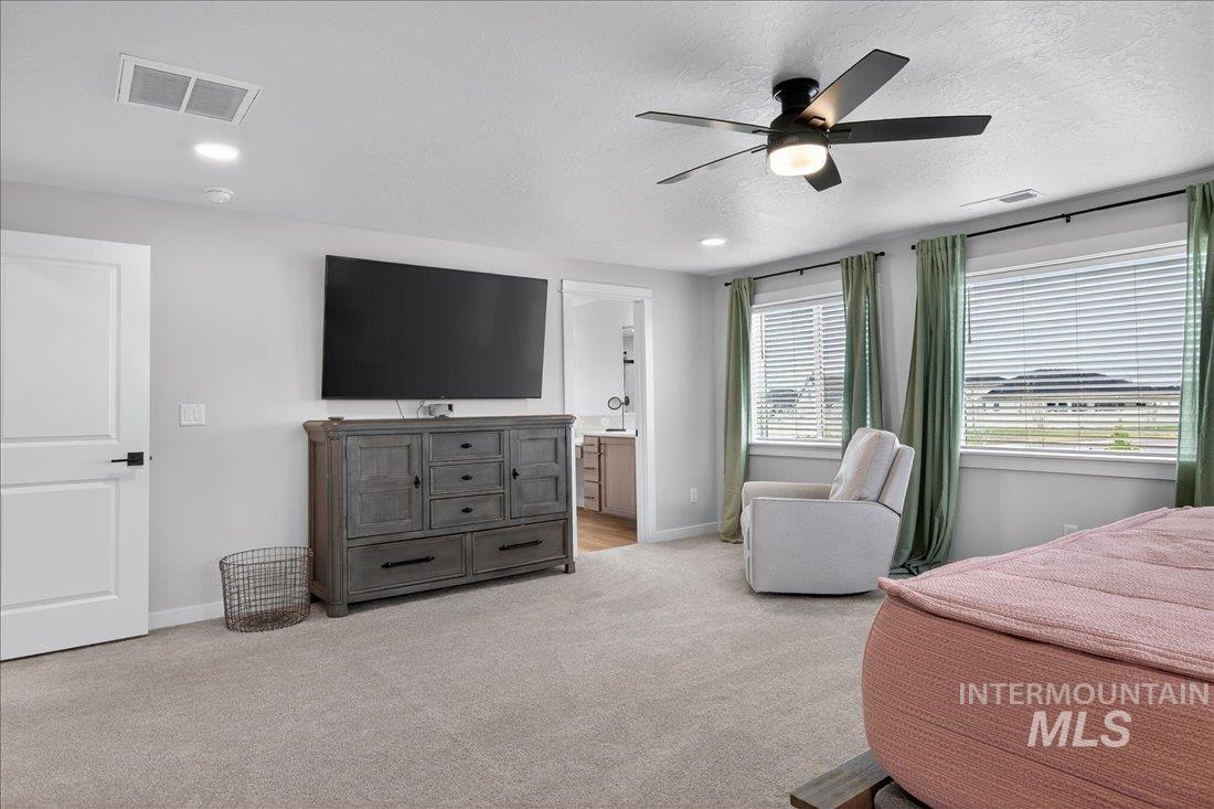 1993 North Perth Court Middleton, ID 83644 - Photo 23 of 45 Bedroom with ceiling fan, light colored carpet, ensuite bath, recessed lighting, and a textured ceiling