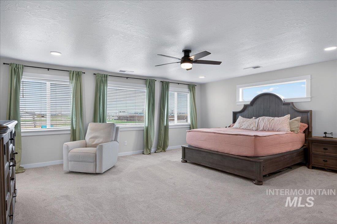 1993 North Perth Court Middleton, ID 83644 - Photo 4 of 45 Bedroom with a textured ceiling, a ceiling fan, light carpet, and recessed lighting
