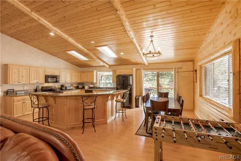 a living room with lots of furniture and view of kitchen
