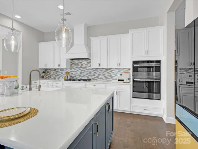 a kitchen with a sink a stove and cabinets