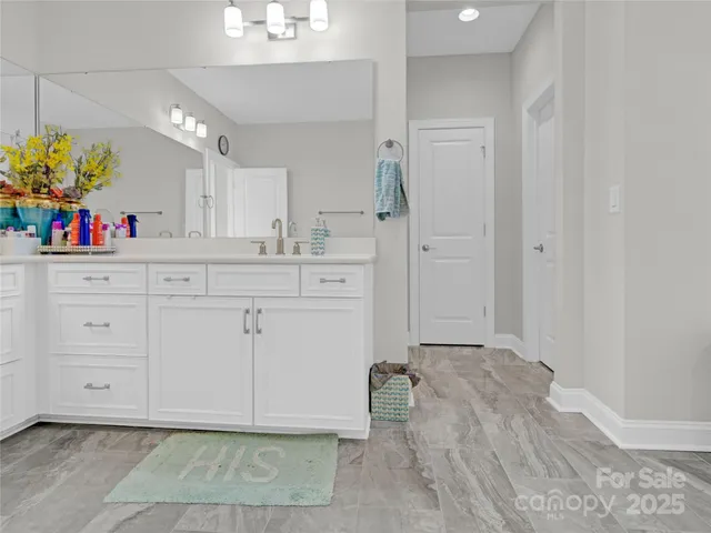 a spacious bathroom with a sink mirror and vanity
