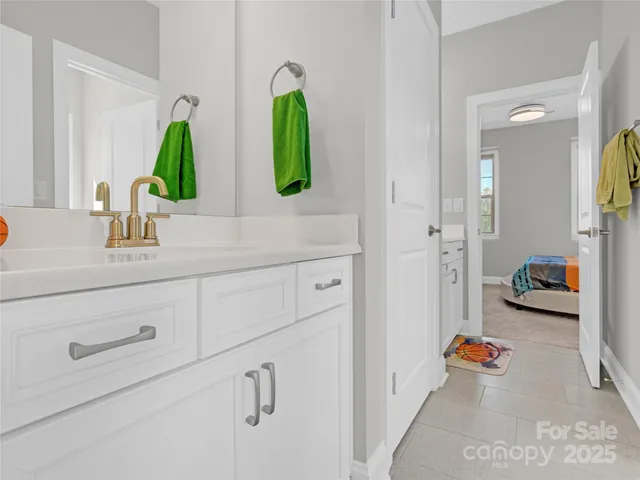 a bathroom with a sink mirror and vanity