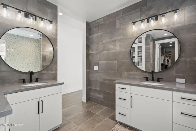 a bathroom with a double vanity sink and a mirror