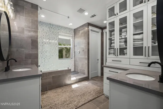 a bathroom with a sink double vanity and a shower
