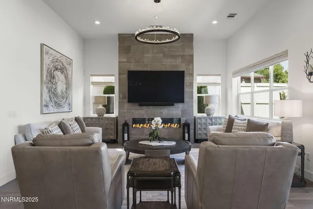 a living room with furniture a fireplace and a flat screen tv