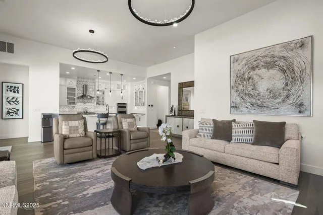 a living room with furniture a rug and a chandelier