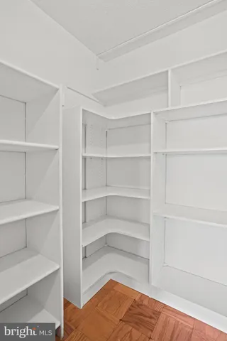 a view of walk in closet with empty racks