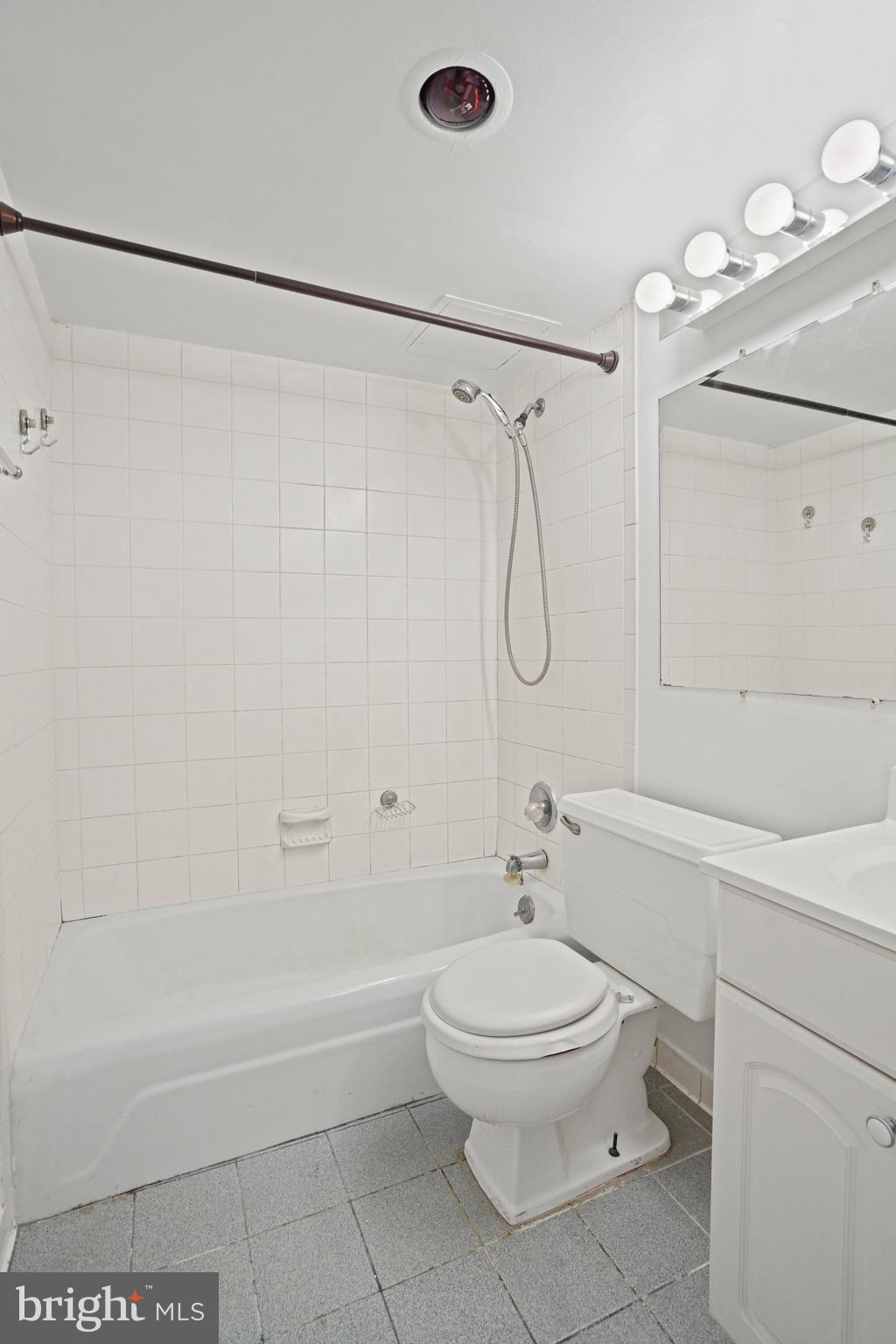 4242 East W Highway, Unit 605 Chevy Chase, MD 20815 - Photo 21 of 46 a bathroom with a toilet sink and shower