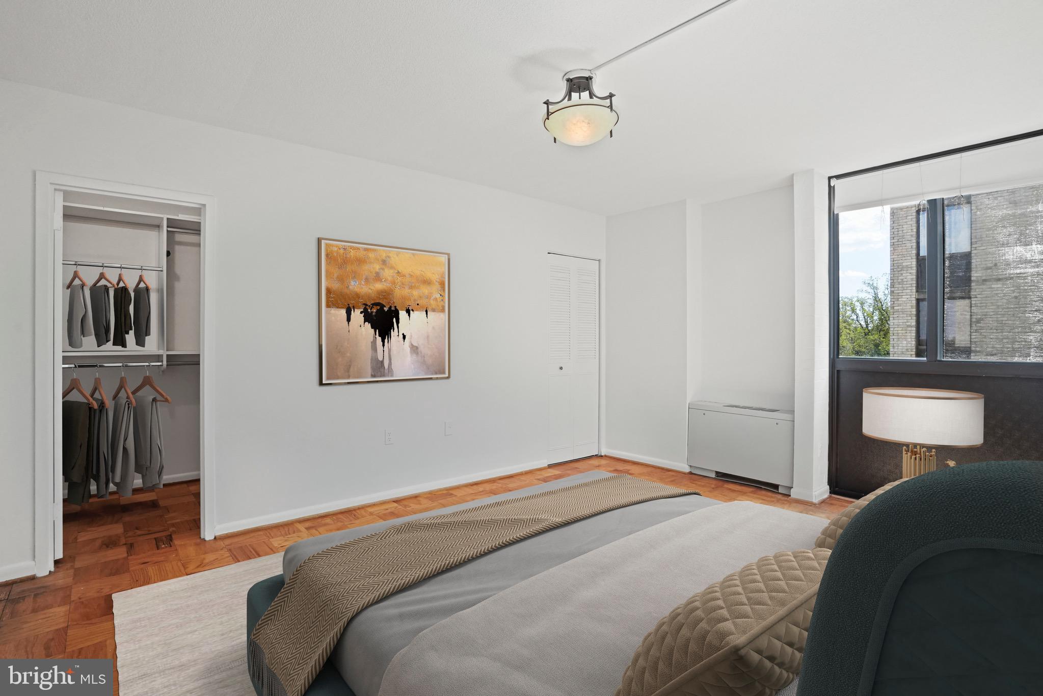 4242 East W Highway, Unit 605 Chevy Chase, MD 20815 - Photo 22 of 46 a bedroom with bed and a window