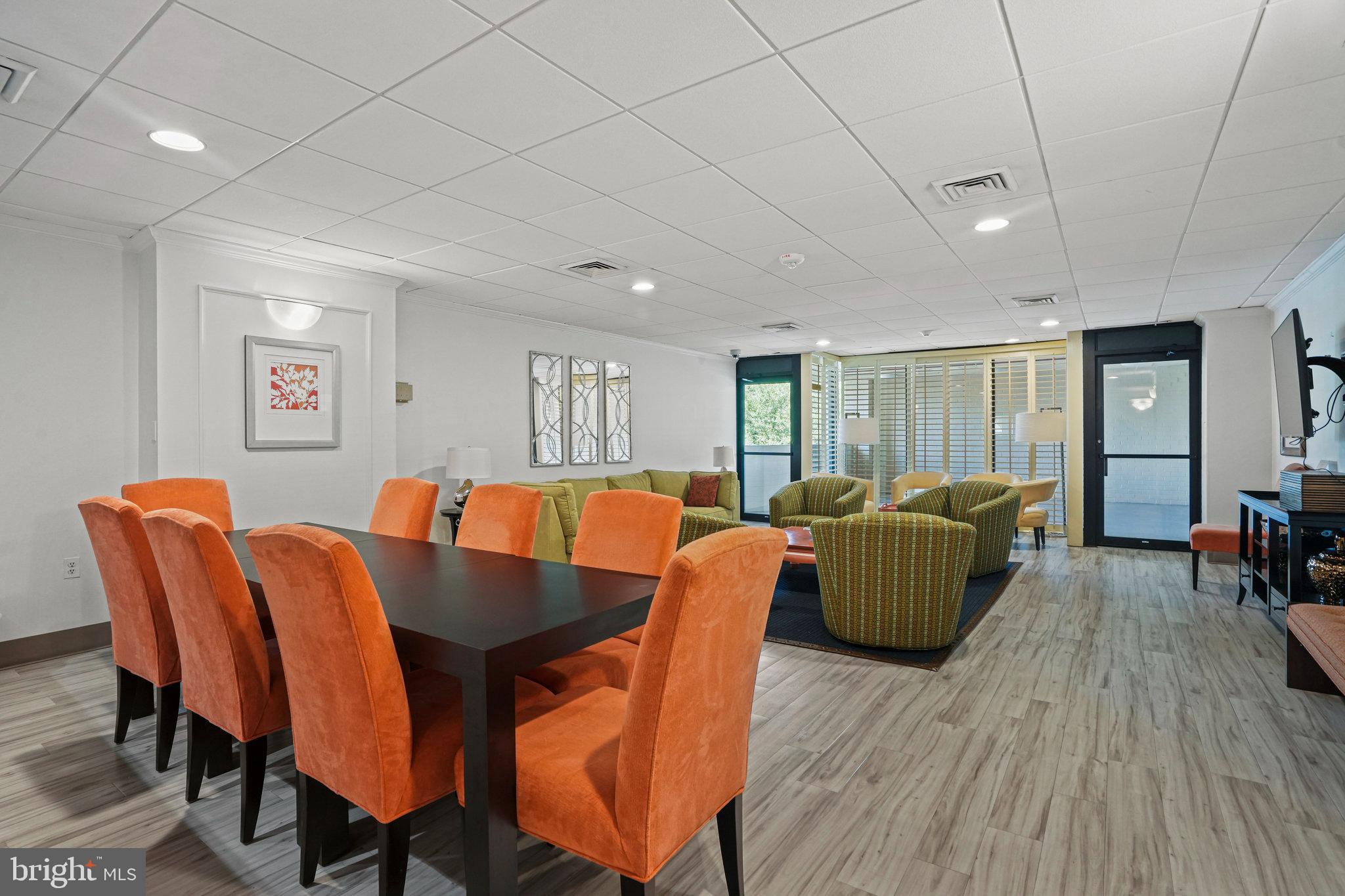 4242 East W Highway, Unit 605 Chevy Chase, MD 20815 - Photo 32 of 46 a dining room with furniture and wooden floor