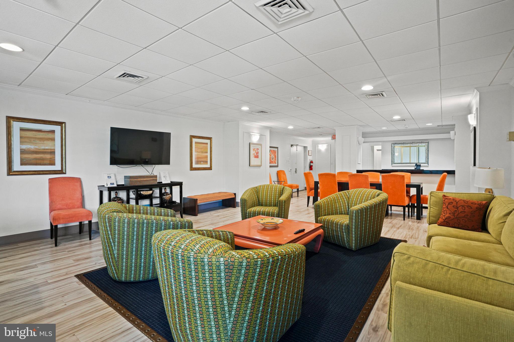 4242 East W Highway, Unit 605 Chevy Chase, MD 20815 - Photo 33 of 46 a living room with furniture kitchen view and a flat screen tv