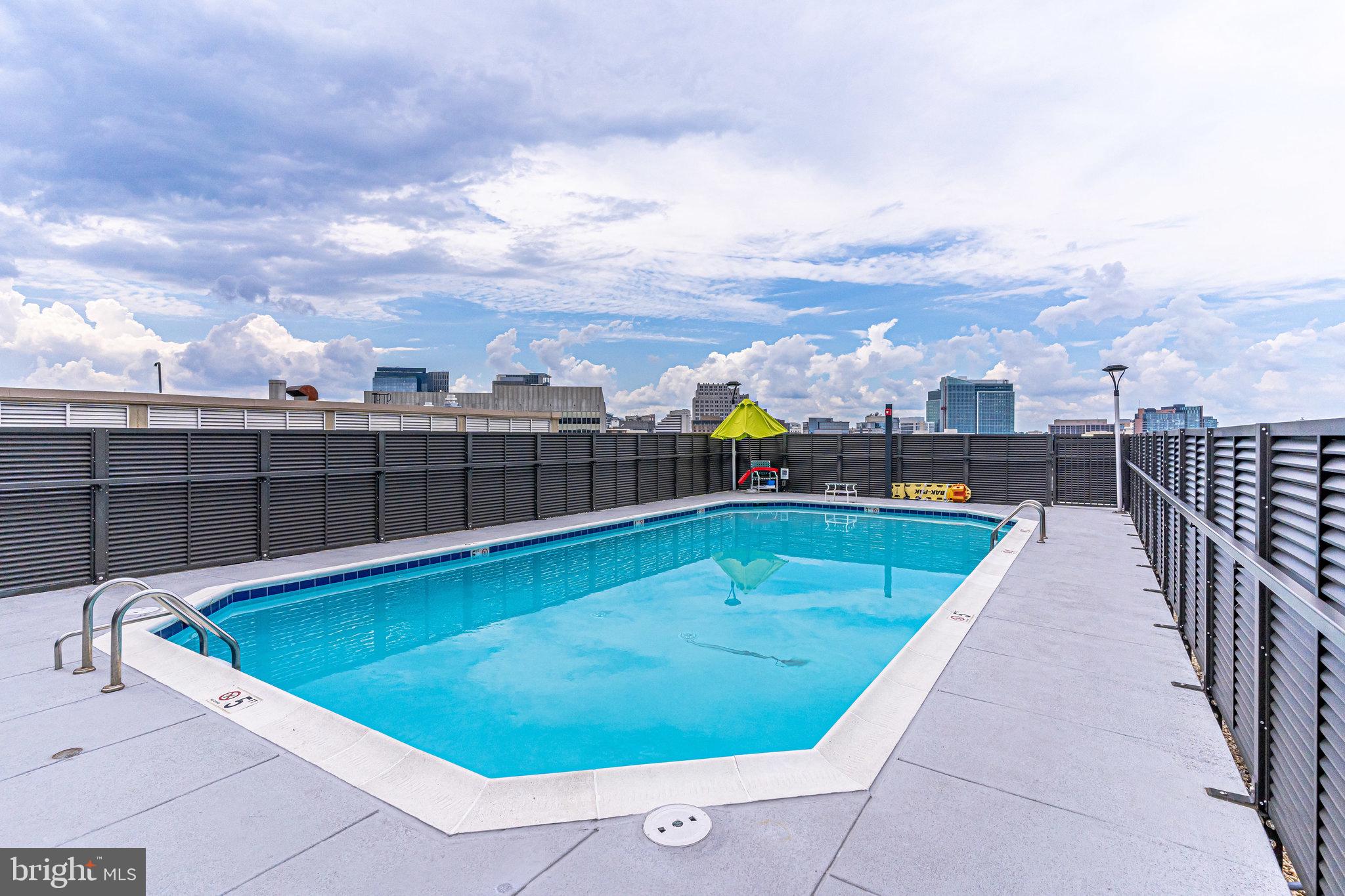 4242 East W Highway, Unit 605 Chevy Chase, MD 20815 - Photo 36 of 46 a view of a swimming pool with a terrace