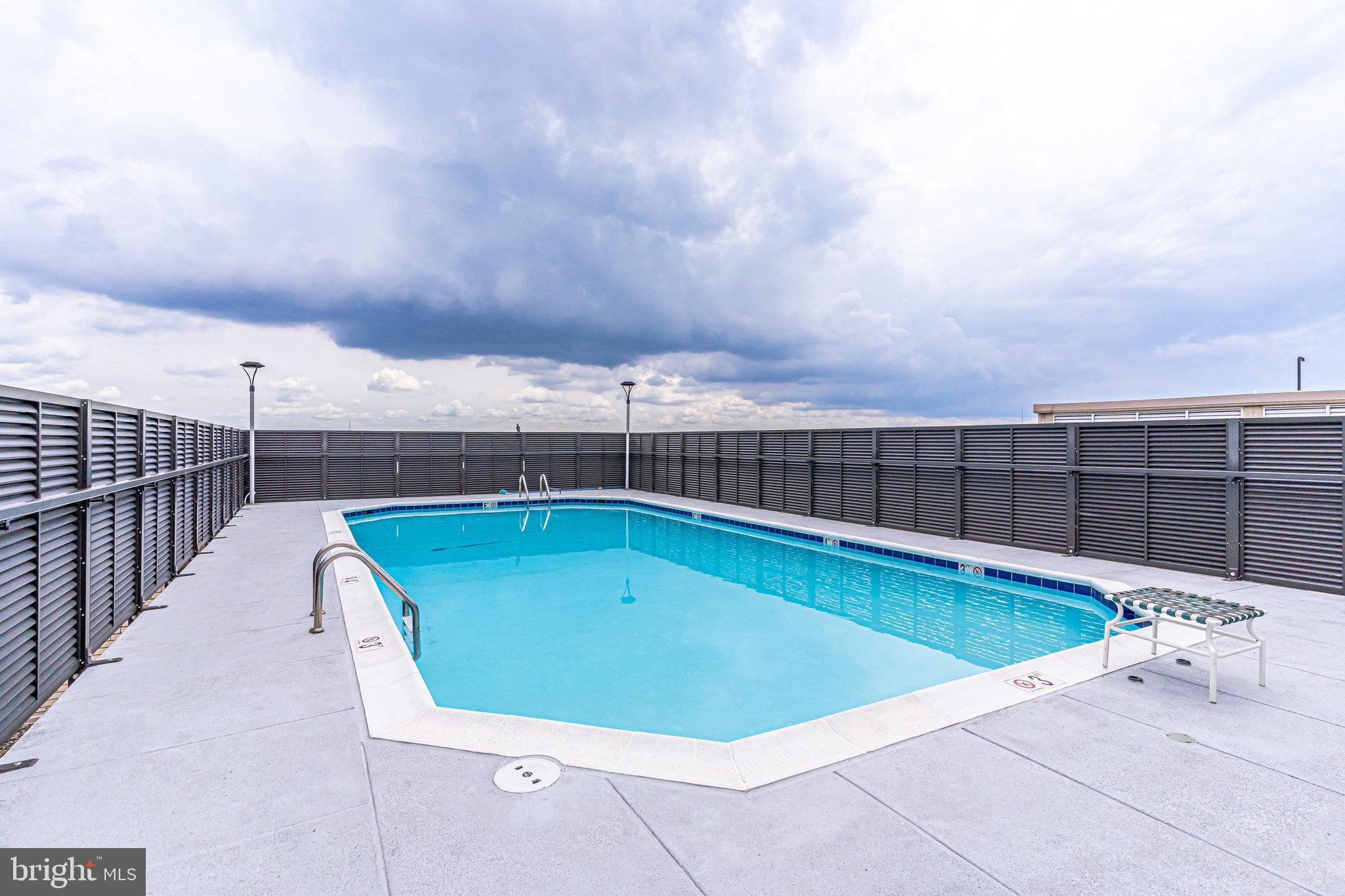 4242 East W Highway, Unit 605 Chevy Chase, MD 20815 - Photo 37 of 46 a view of a swimming pool with a terrace