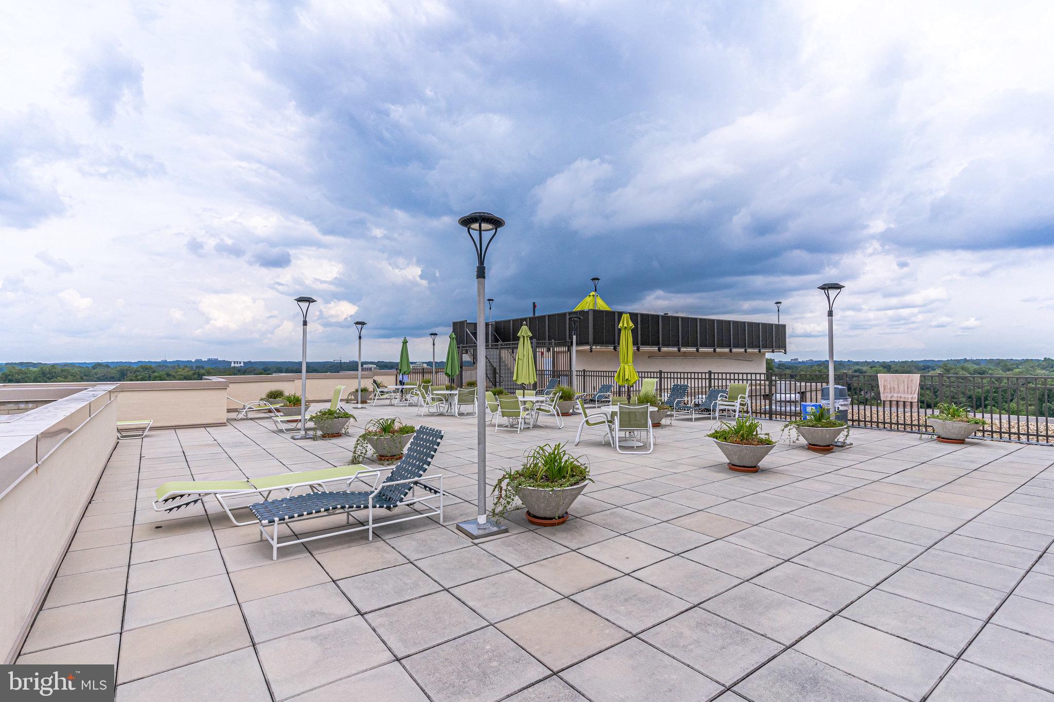 4242 East W Highway, Unit 605 Chevy Chase, MD 20815 - Photo 38 of 46 a view of a terrace with furniture and a stove
