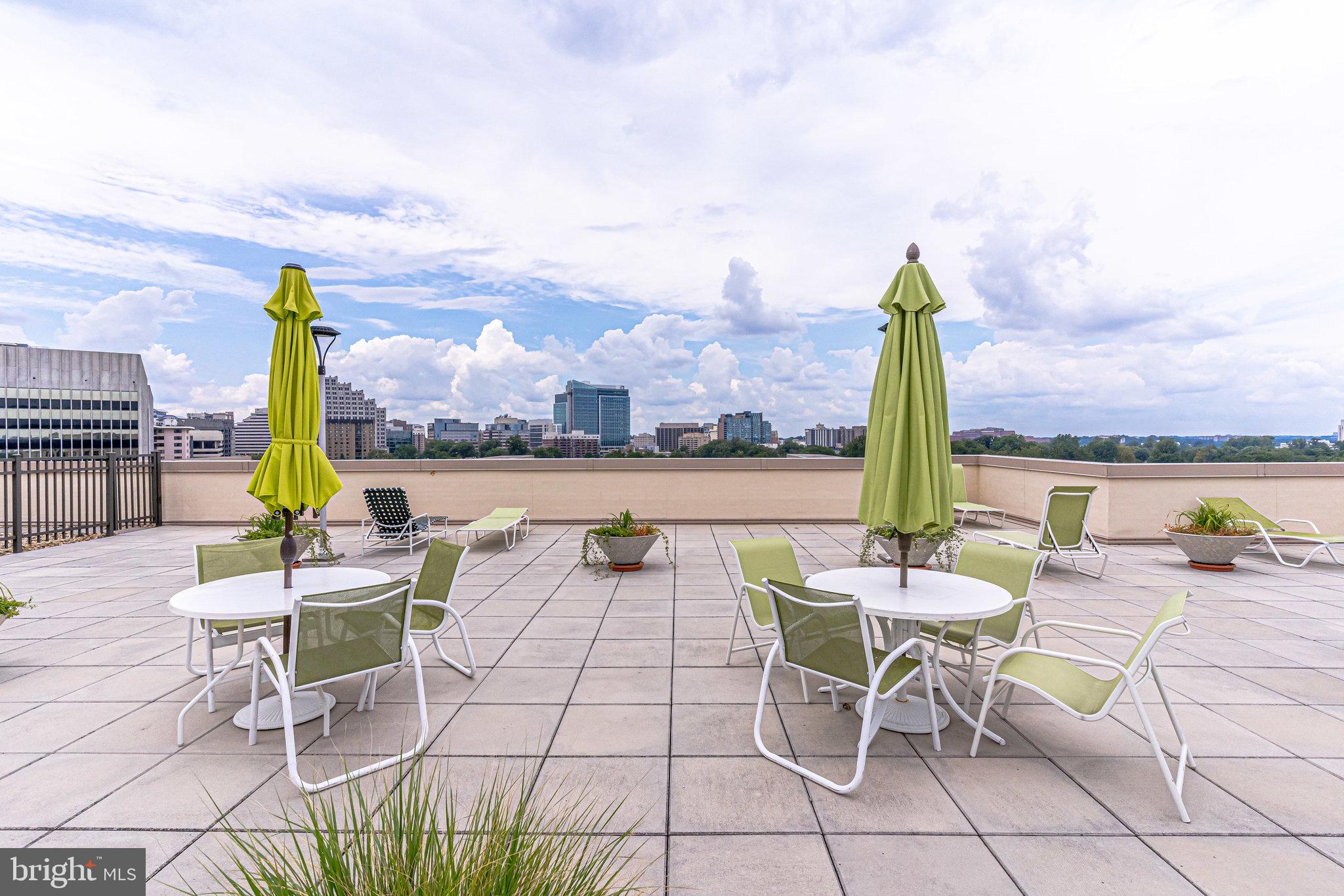 4242 East W Highway, Unit 605 Chevy Chase, MD 20815 - Photo 42 of 46 a view of a terrace with furniture and a table