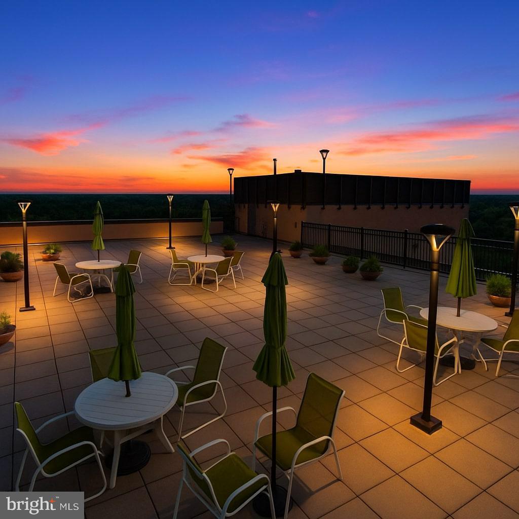 4242 East W Highway, Unit 605 Chevy Chase, MD 20815 - Photo 46 of 46 a view of a patio with chairs and a table