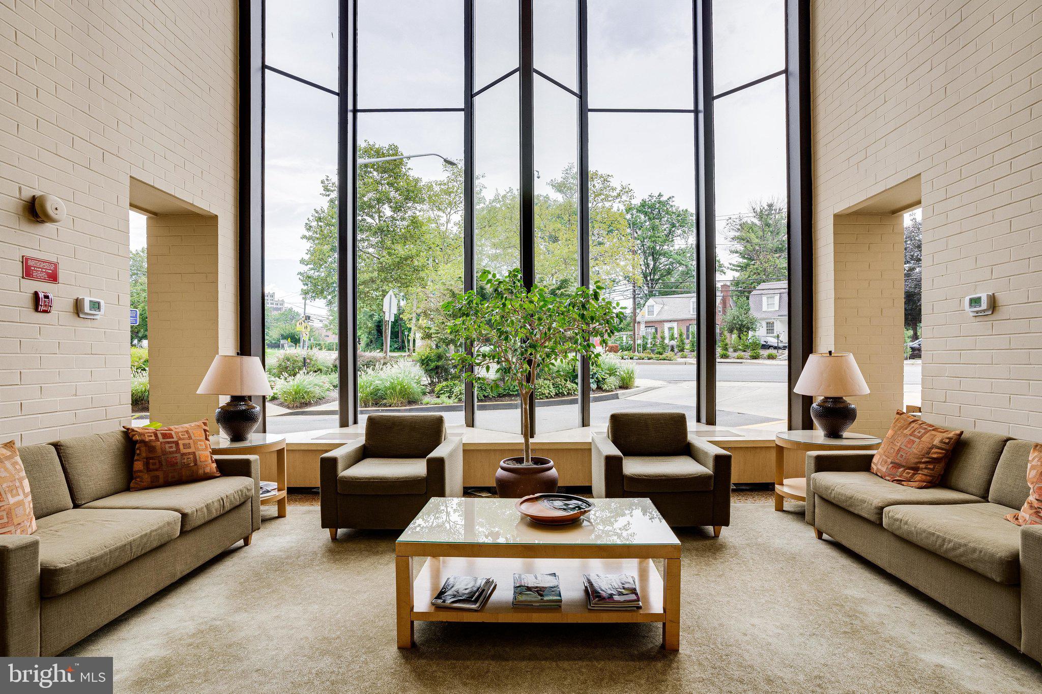4242 East W Highway, Unit 605 Chevy Chase, MD 20815 - Photo 10 of 46 a living room with furniture and a large window