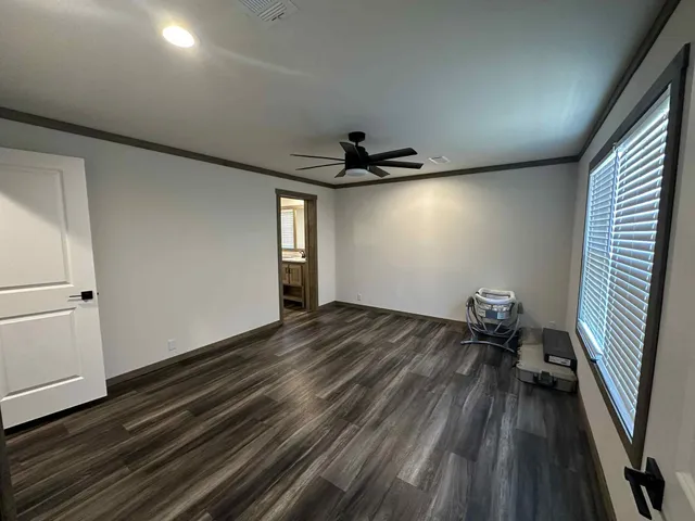 a view of empty room with wooden floor