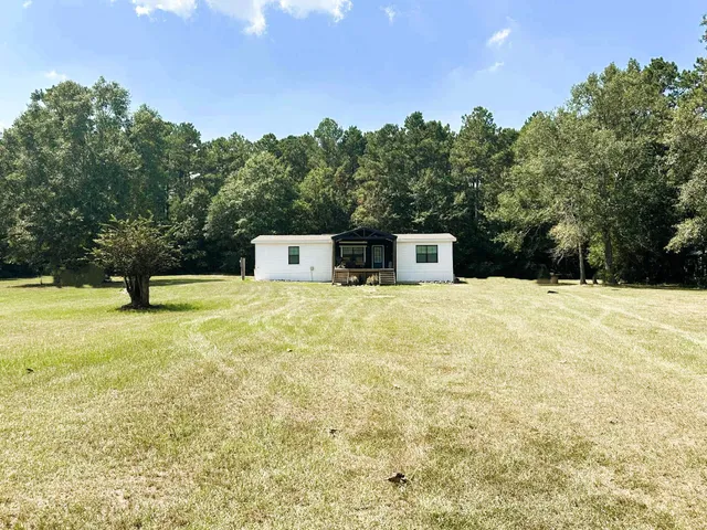 a swimming pool with trees in the background