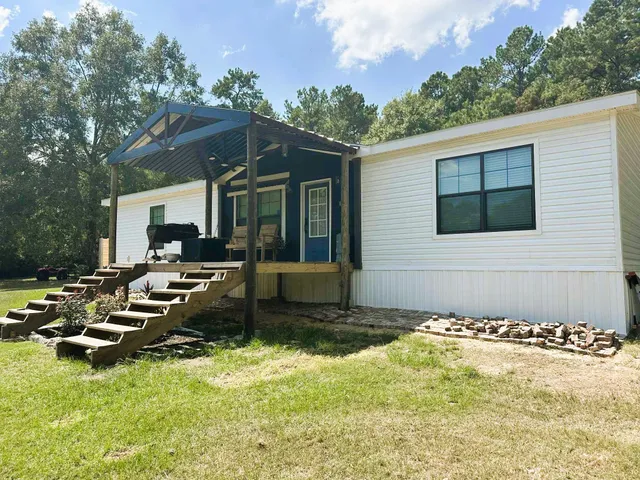 a backyard of a house with yard and outdoor seating