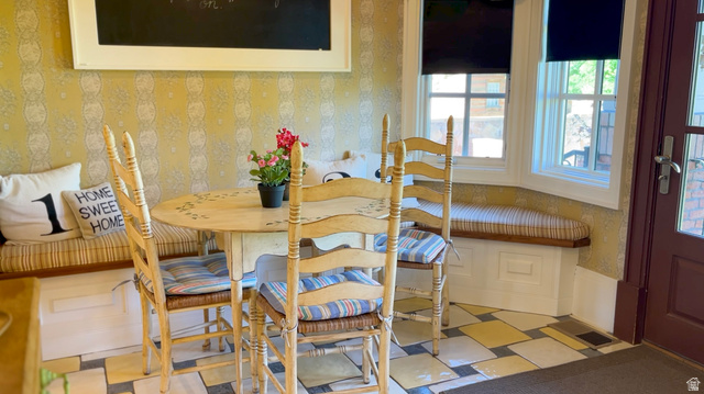 426 West Center Street Parowan, UT 84761 - Photo 39 of 107 Breakfast nook featuring a built-in window seat with storage, decorative wallpaper, and a dark wood-paneled door