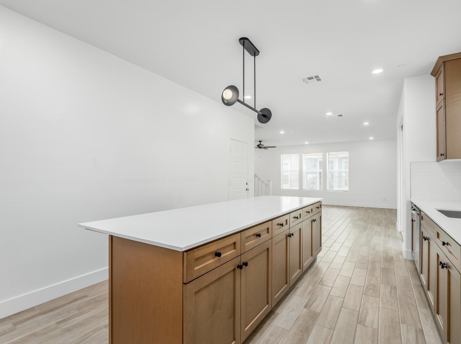 2734 East Teaberry Drive Fresno, CA 93730 - Photo 11 of 34 a kitchen with a stove and a wooden floor