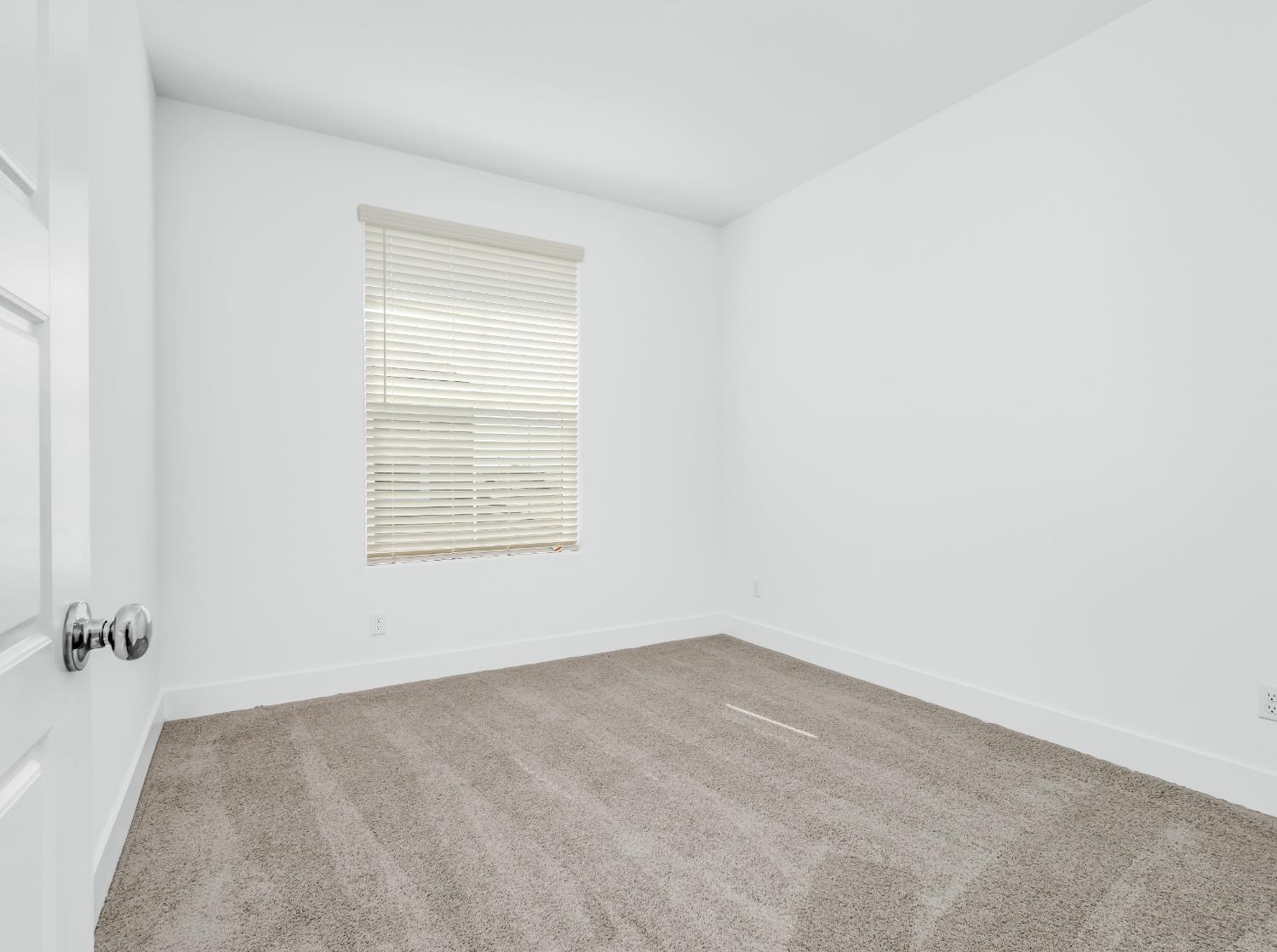 2734 East Teaberry Drive Fresno, CA 93730 - Photo 17 of 34 an empty room with a window