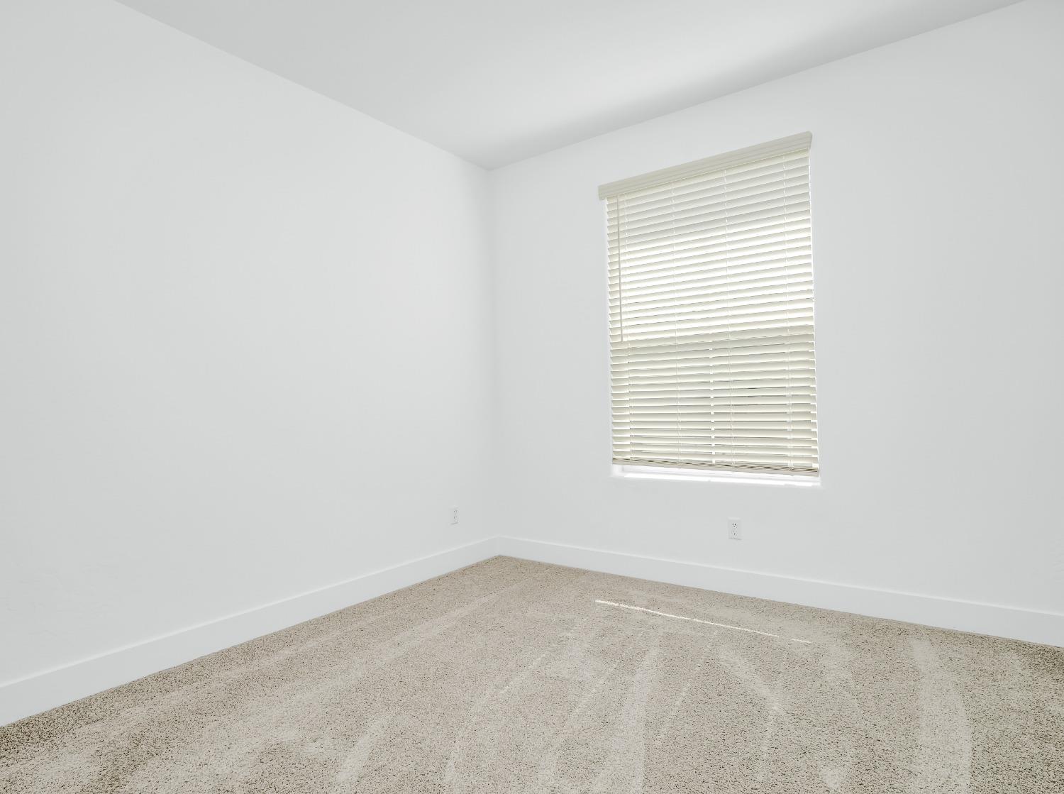 2734 East Teaberry Drive Fresno, CA 93730 - Photo 19 of 34 an empty room with a window