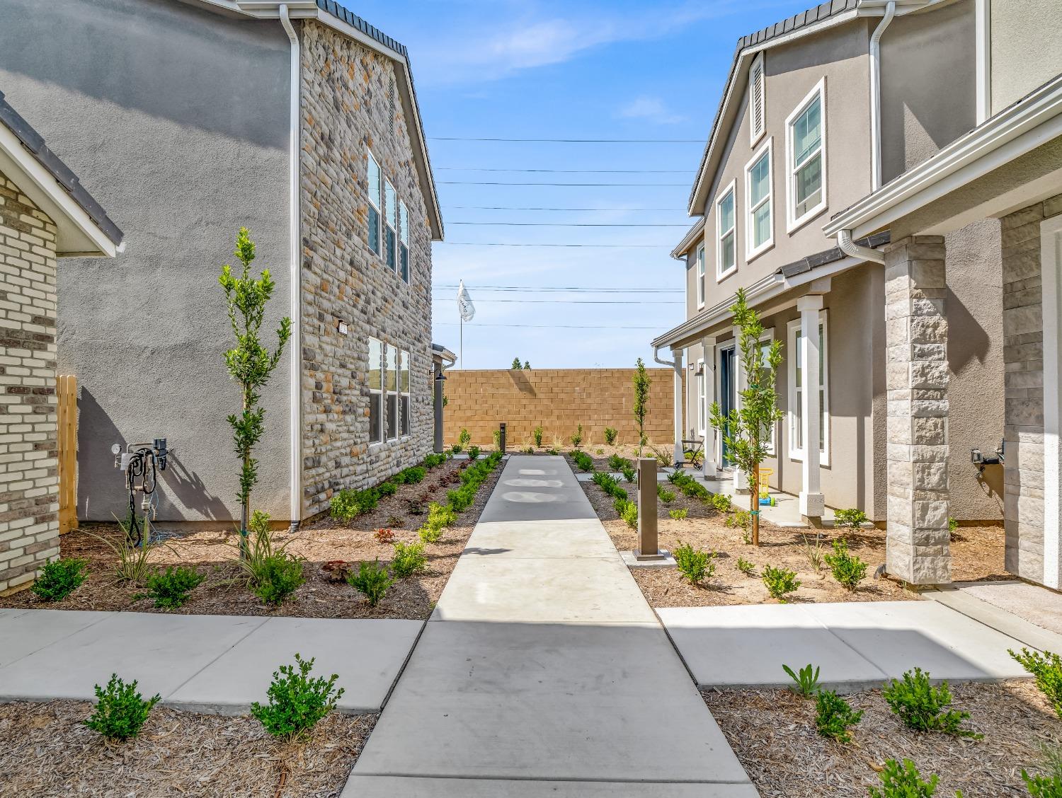 2734 East Teaberry Drive Fresno, CA 93730 - Photo 2 of 34 a view of a brick building next to a yard
