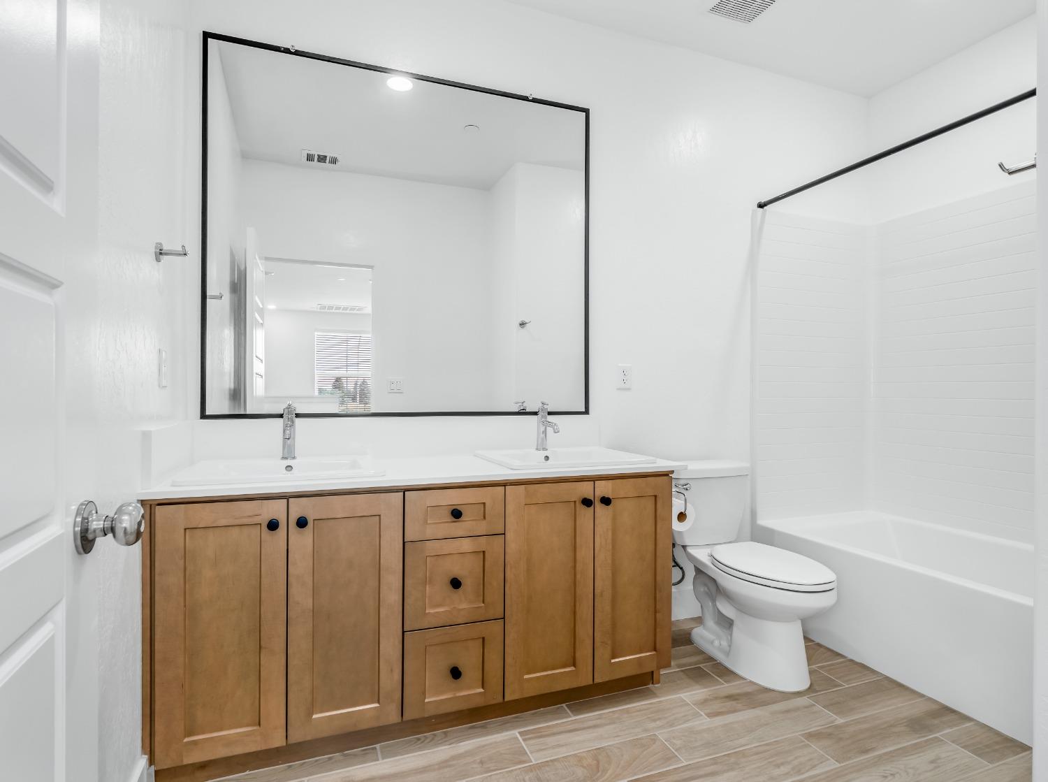 2734 East Teaberry Drive Fresno, CA 93730 - Photo 21 of 34 a bathroom with a sink a toilet and a mirror
