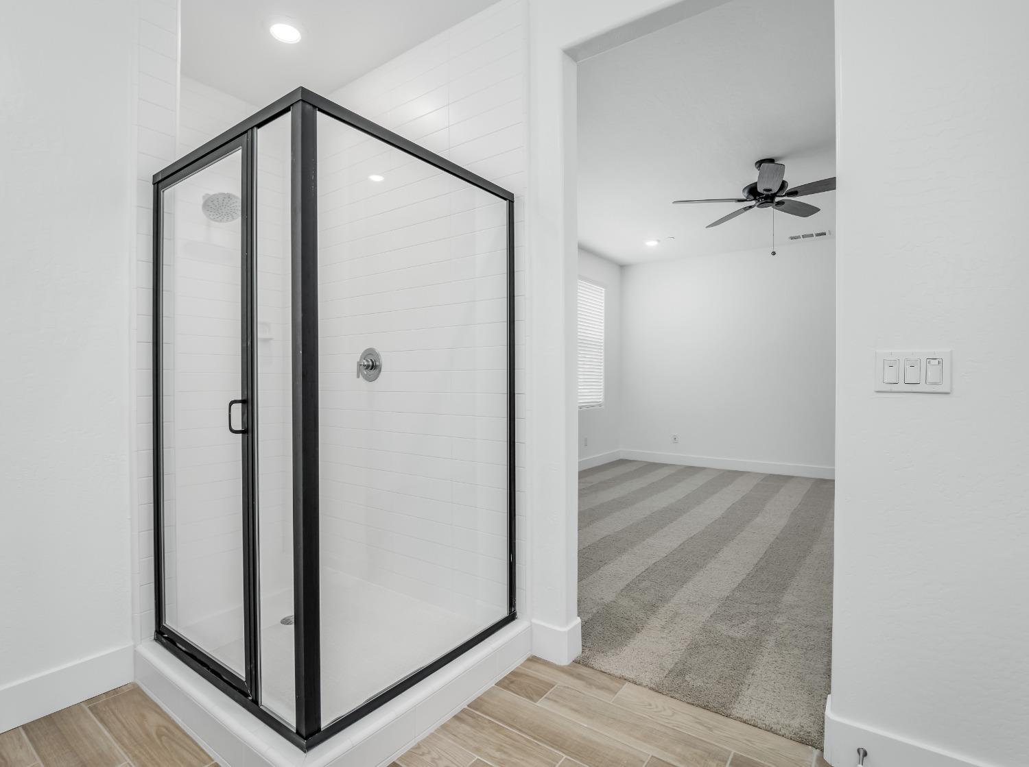 2734 East Teaberry Drive Fresno, CA 93730 - Photo 27 of 34 a bathroom with a shower and a glass door
