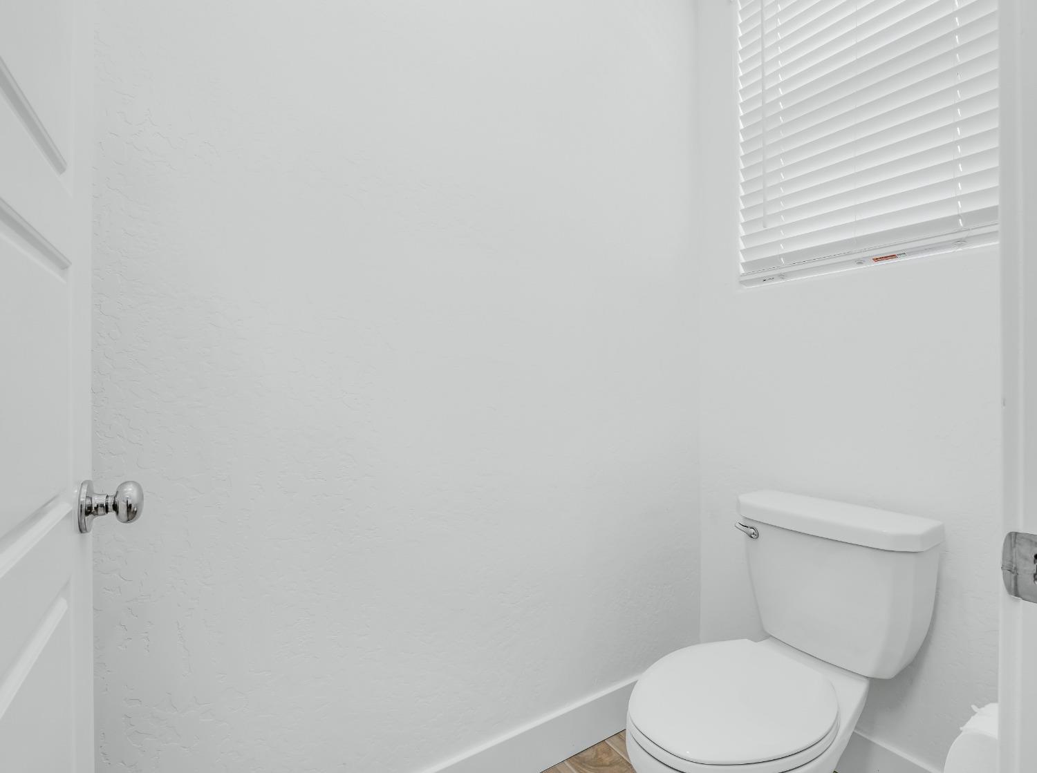 2734 East Teaberry Drive Fresno, CA 93730 - Photo 29 of 34 a white toilet sitting next to a white sink