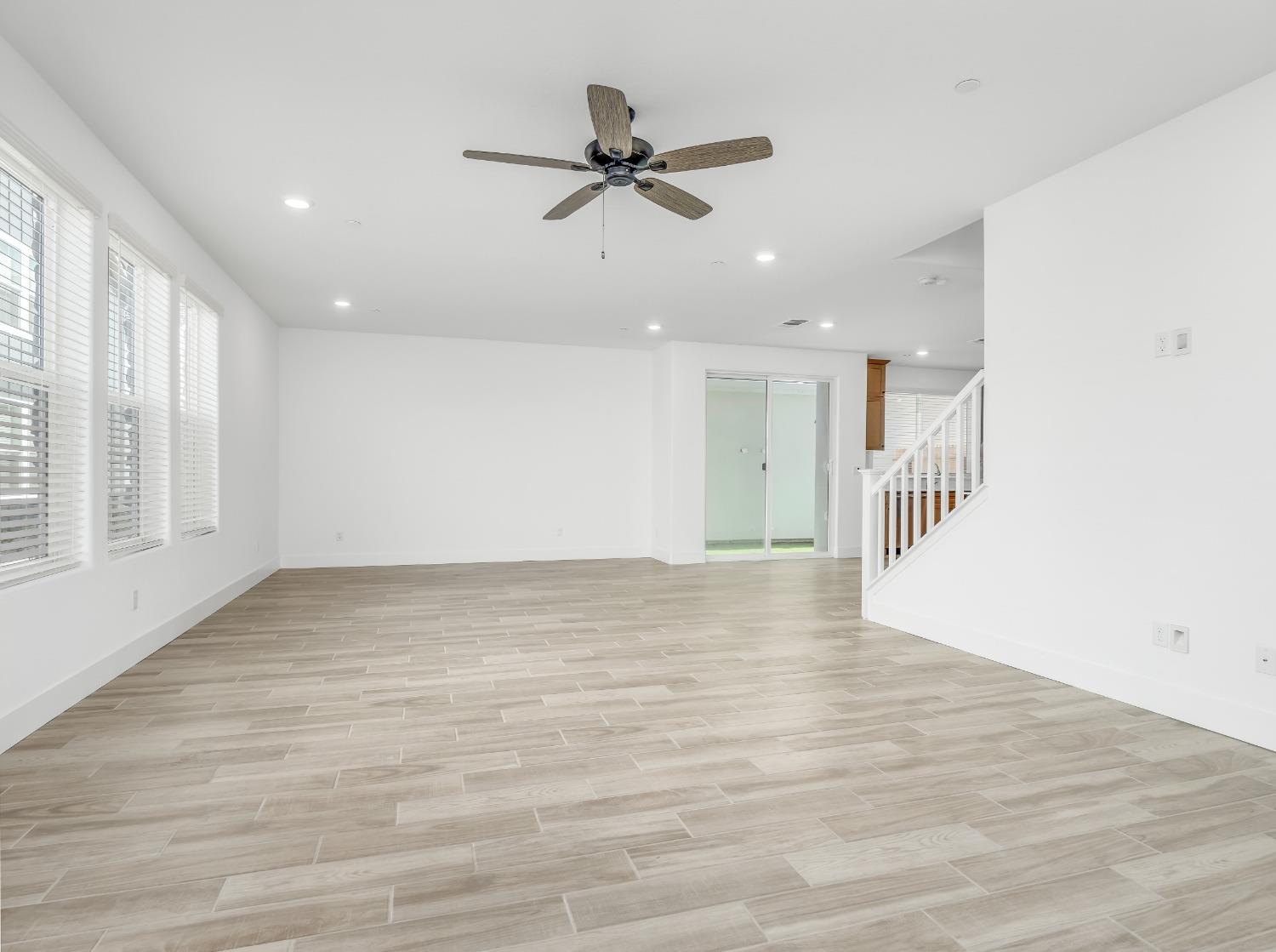 2734 East Teaberry Drive Fresno, CA 93730 - Photo 3 of 34 a view of an empty room with wooden floor and a window
