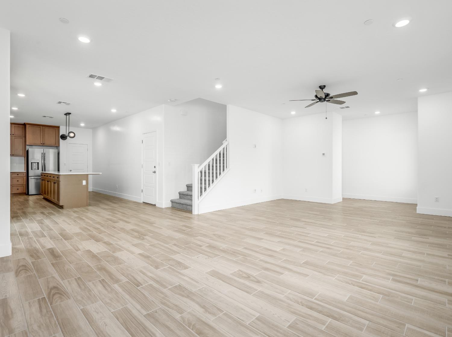 2734 East Teaberry Drive Fresno, CA 93730 - Photo 6 of 34 a view of a kitchen with a sink and a refrigerator