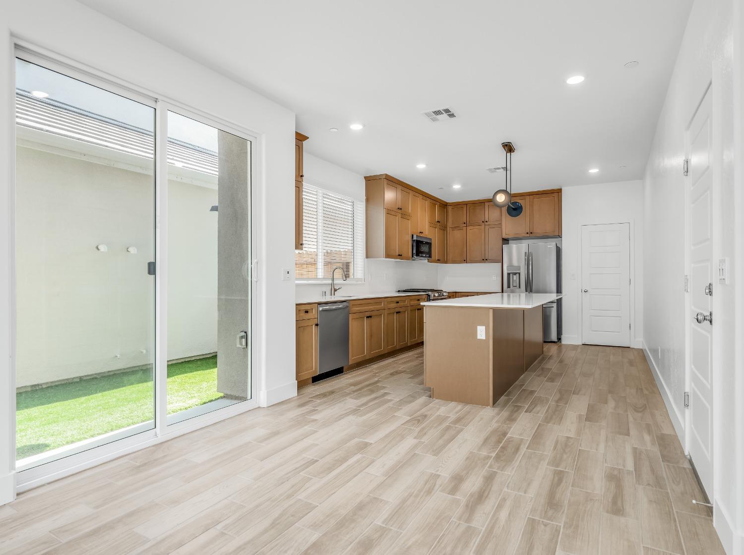 2734 East Teaberry Drive Fresno, CA 93730 - Photo 9 of 34 a kitchen with a sink a counter top space and stainless steel appliances
