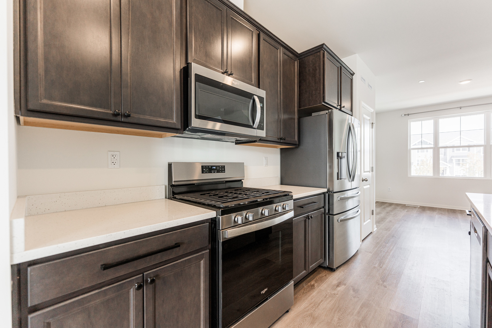 2016 Yellowstone Boulevard Mundelein, IL 60060 - Photo 7 of 30 a kitchen with stainless steel appliances a stove microwave and wooden floor