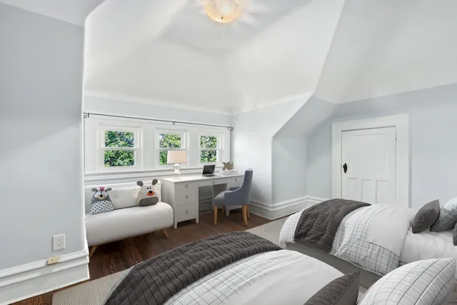 a bedroom with two beds and a couch