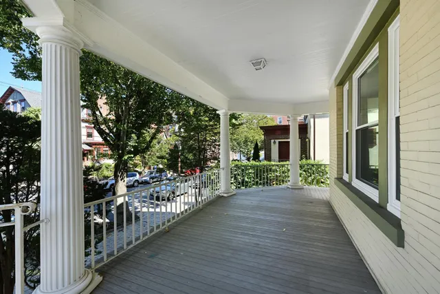 a view of a porch with wooden floor