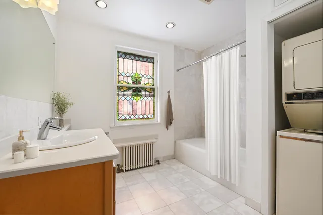 a en suite bathroom with a sink a bathtub and a mirror