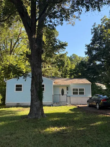 a aerial view of a house with swimming pool next to a yard