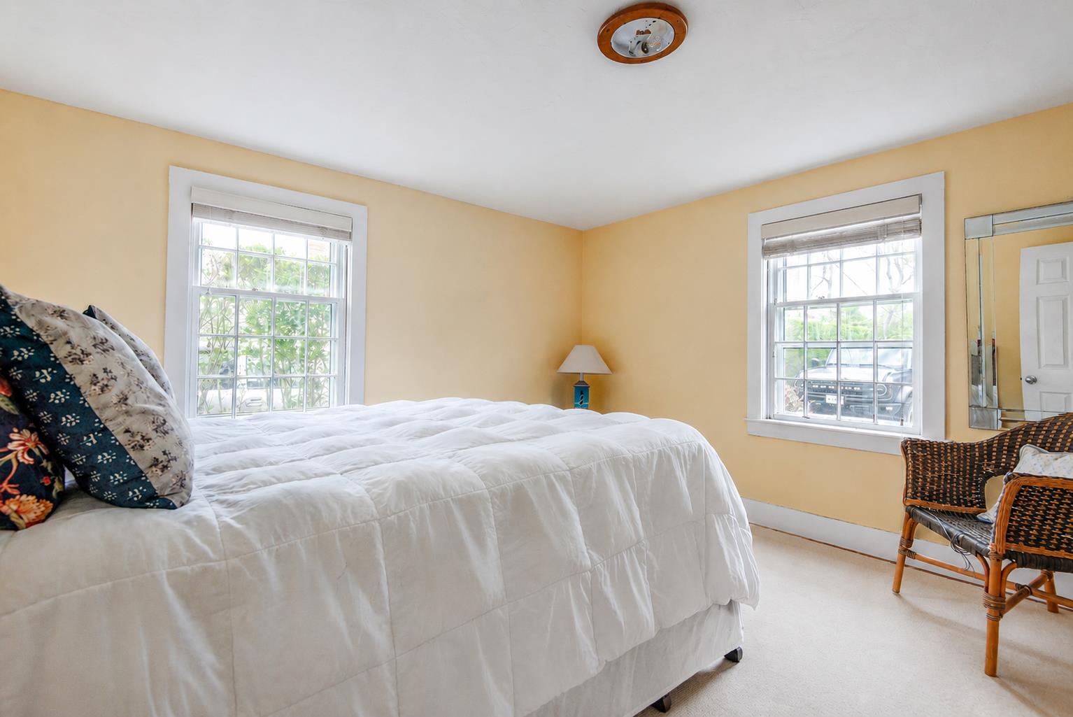12 King Street Nantucket, MA 02554 - Photo 18 of 32 a spacious bedroom with a bed and a couch