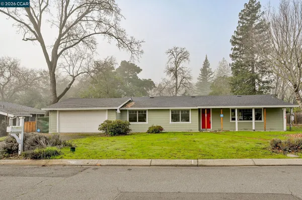 a view of house that has a yard
