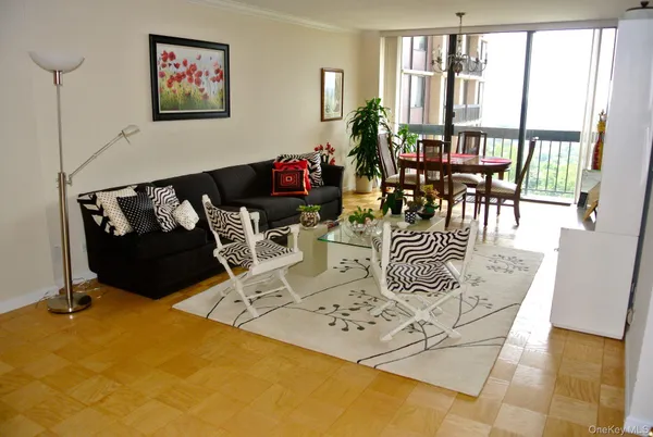 a living room with furniture windows and a dining table