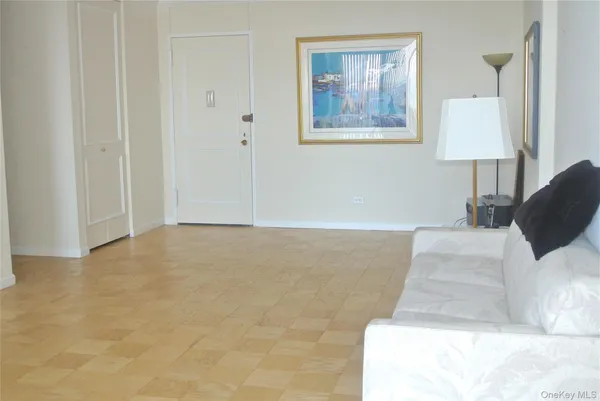 a view of a bedroom with a large bed and a lamp on table