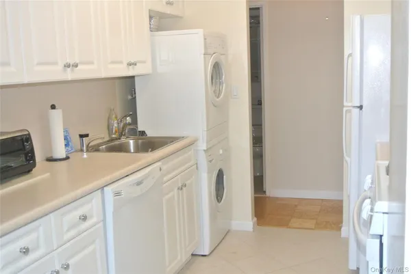 a kitchen with appliances a sink and cabinets