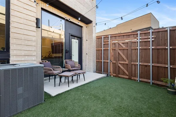 a building outdoor space with patio furniture and potted plants