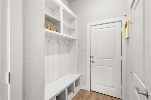 a view of an entryway with wooden floor