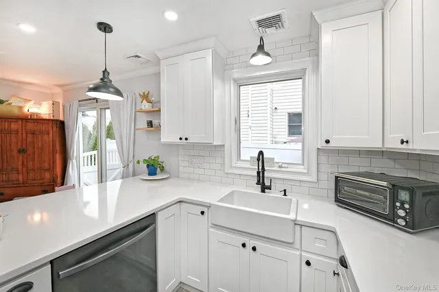 a kitchen with stainless steel appliances a sink stove and cabinets