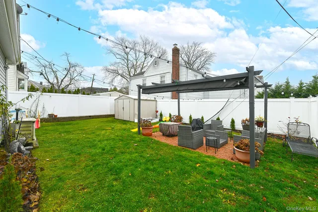 a view of backyard with seating area and trees